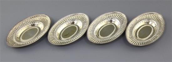 A set of four George III embossed silver gilt oval nut dishes by John Emes, 8 oz.